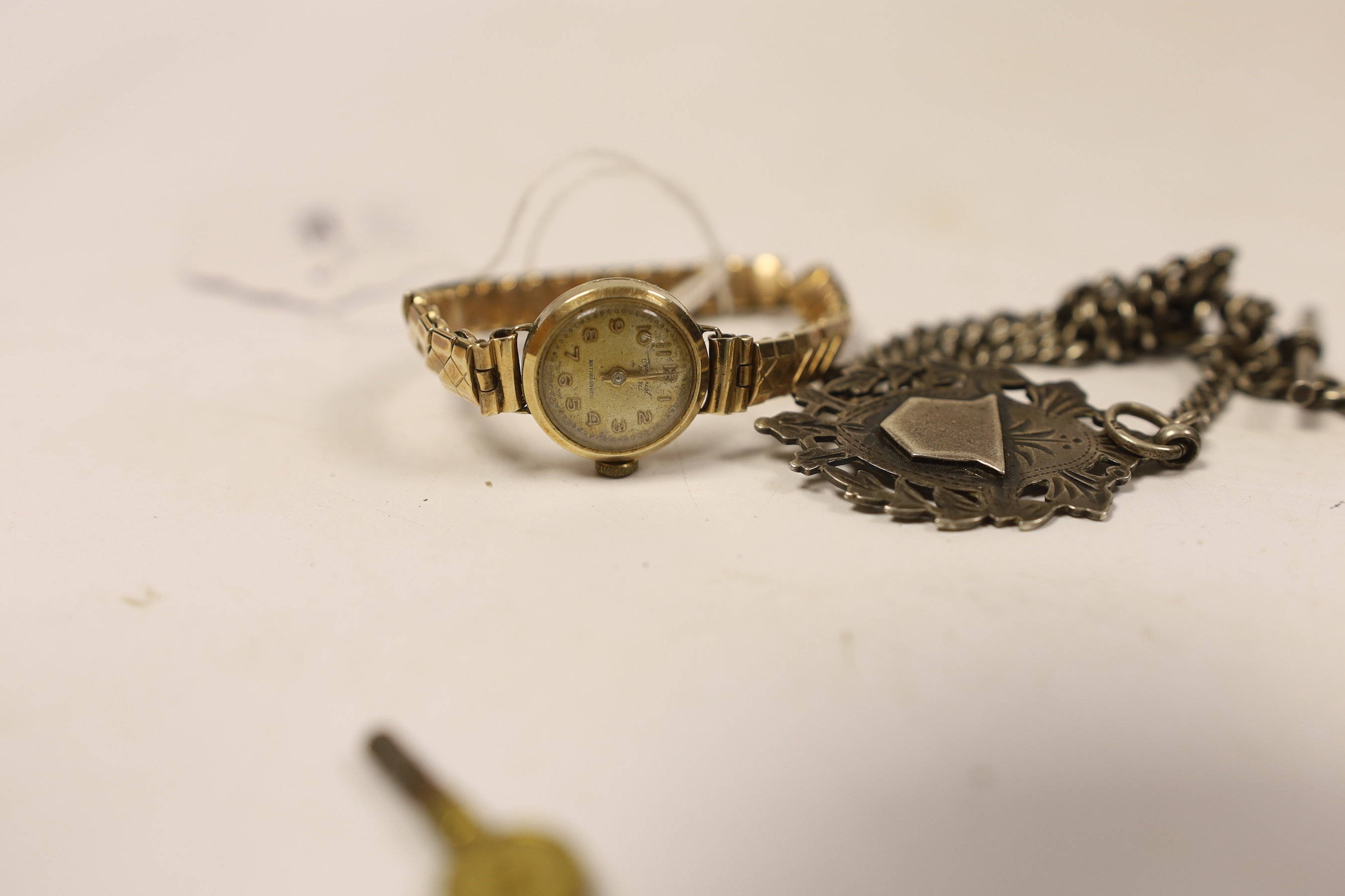A silver vesta case, on a silver albert, with silver medallion, a lady's 9ct gold manual wind wrist watch, on a gold plated bracelet, a gold plated hunter pocket watch a silver pusher and a George III silver and agate mo